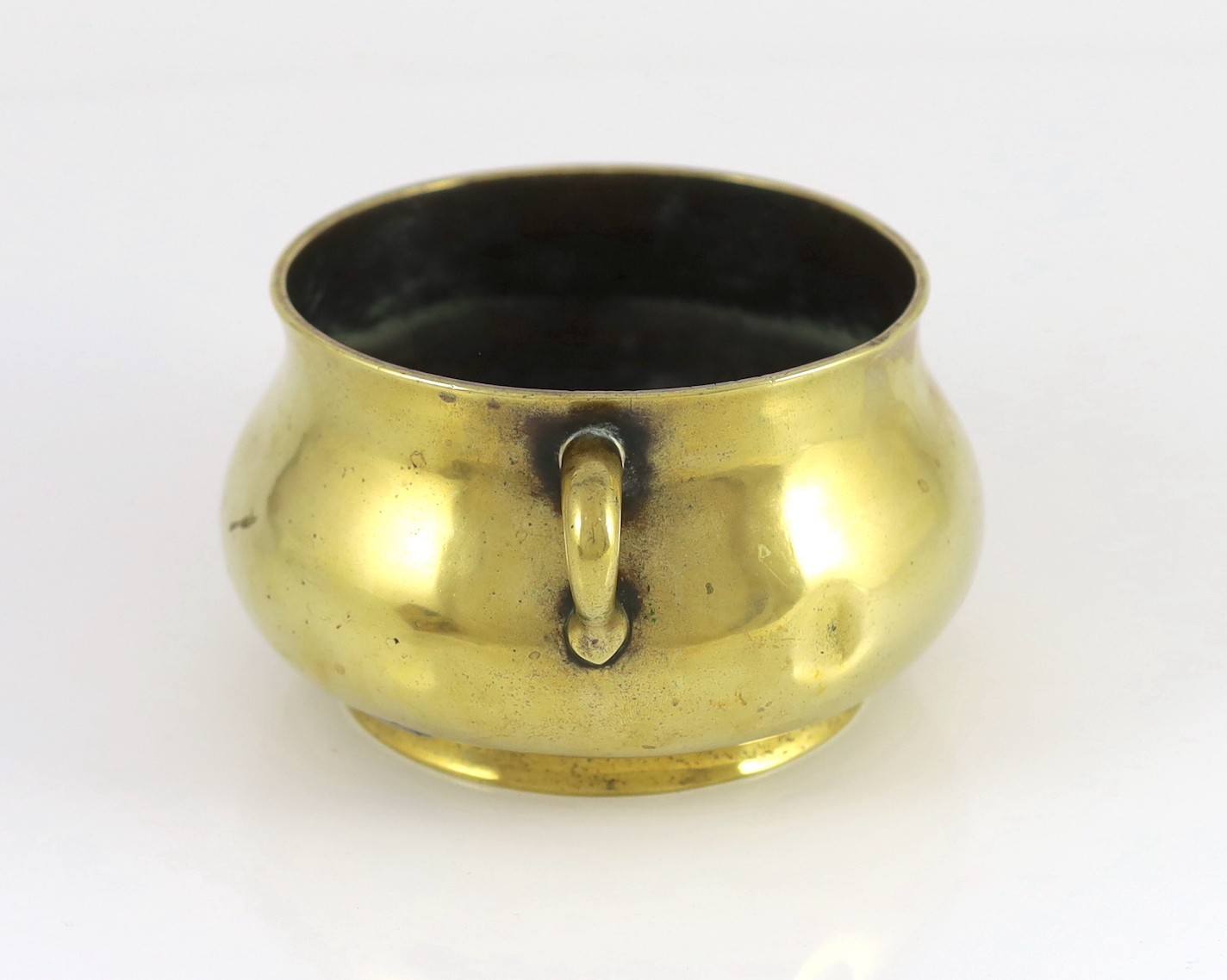 A Chinese polished bronze censer, gui, Xuande six character mark, 18th/19th century, 19cm wide, dented, solder repair